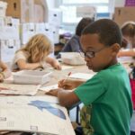 children learning from books in classroom