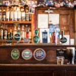 Various alcoholic beverages on draft in a pub